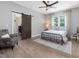 Bedroom featuring a dark barn door, an upholstered chair, and a large window at 67 Spring Hollow Ct, Pittsboro, NC 27312
