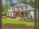 Beautiful home showcasing a covered front porch with wood columns and well-maintained landscaping at 67 Spring Hollow Ct, Pittsboro, NC 27312