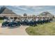 Row of golf carts parked neatly in front of the clubhouse in Chapel Ridge at 67 Spring Hollow Ct, Pittsboro, NC 27312