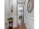 Bright hallway with decorative trim, hardwood floors, and stylish decor leading to the bedroom at 67 Spring Hollow Ct, Pittsboro, NC 27312