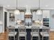 Well-appointed kitchen features a large island with counter seating, custom cabinets, and modern pendant lighting at 67 Spring Hollow Ct, Pittsboro, NC 27312