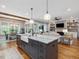 Bright and airy kitchen featuring a central island, perfect for entertaining, and seamless access to the living area at 67 Spring Hollow Ct, Pittsboro, NC 27312