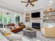 Inviting living room features a cozy fireplace, stylish decor, and seamless access to the outdoor living space at 67 Spring Hollow Ct, Pittsboro, NC 27312