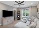 Comfortable living room with plush seating, modern media center, and bright windows at 67 Spring Hollow Ct, Pittsboro, NC 27312
