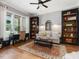 Comfortable living room featuring hardwood floors, built-in bookshelves, and a cozy seating area at 67 Spring Hollow Ct, Pittsboro, NC 27312