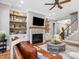 The open living room showcases a fireplace with decorative shelves and a staircase leading to the second floor at 67 Spring Hollow Ct, Pittsboro, NC 27312