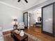 Cozy living room with a decorative rug and hardwood floors, with an opening to another living space at 67 Spring Hollow Ct, Pittsboro, NC 27312