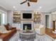 Bright living room boasts a fireplace with stylish shelves and cabinets on either side, enhancing the cozy atmosphere at 67 Spring Hollow Ct, Pittsboro, NC 27312