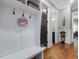 Mudroom features coat hooks, storage baskets, a built-in bench, and a view to the bathroom at 67 Spring Hollow Ct, Pittsboro, NC 27312