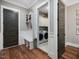 Mudroom with bench, coat hooks, and access to the laundry room, all illuminated by natural light at 67 Spring Hollow Ct, Pittsboro, NC 27312