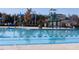 Community pool with slide and striped awning, offering a fun and refreshing outdoor amenity at 67 Spring Hollow Ct, Pittsboro, NC 27312