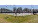 Community tennis court enclosed by a fence, providing a space for friendly matches and exercise at 67 Spring Hollow Ct, Pittsboro, NC 27312