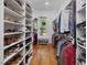 Spacious walk-in closet with custom shelving and storage, offering ample space for clothing and shoes at 67 Spring Hollow Ct, Pittsboro, NC 27312