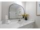 Bathroom featuring a modern vanity with a black arched mirror and elegant decor at 7216 Carlton Dr, Raleigh, NC 27616
