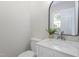 Bathroom features a modern vanity with marble countertop, oval mirror, and decorative succulent at 7216 Carlton Dr, Raleigh, NC 27616