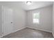 Well-lit bedroom features neutral walls, carpeted floors, and a window providing plenty of natural light at 7216 Carlton Dr, Raleigh, NC 27616
