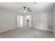 Spacious bedroom featuring a ceiling fan, neutral walls, carpeted floors, and ensuite bathroom at 7216 Carlton Dr, Raleigh, NC 27616