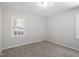 Bright bedroom features neutral walls, carpeted floors, and a window providing plenty of natural light at 7216 Carlton Dr, Raleigh, NC 27616