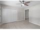 Bright bedroom features a ceiling fan, neutral walls, light wood floors, and a large closet at 7216 Carlton Dr, Raleigh, NC 27616