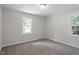 Bright bedroom features neutral walls, carpeted floors, and large windows providing outdoor views at 7216 Carlton Dr, Raleigh, NC 27616