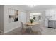 Bright dining room with modern light fixture and table, adjacent to updated kitchen at 7216 Carlton Dr, Raleigh, NC 27616