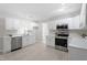 Bright kitchen with white cabinets, stainless steel appliances, and a modern backsplash at 7216 Carlton Dr, Raleigh, NC 27616
