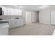 Open-concept living room with light vinyl floors and abundant natural light at 7216 Carlton Dr, Raleigh, NC 27616