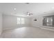 Bright and open living room features a ceiling fan and large windows for natural light at 7216 Carlton Dr, Raleigh, NC 27616