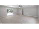 Spacious living room with ceiling fan and sliding glass door with lots of natural light at 7216 Carlton Dr, Raleigh, NC 27616