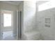 Bright bathroom featuring a tiled shower with a built in bench and nook at 788 Shade Tree Rd, Benson, NC 27504