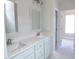Bathroom with double vanity sinks, white cabinets and marble countertops at 788 Shade Tree Rd, Benson, NC 27504