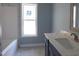 New bathroom with stylish vanity, window, and bath at 788 Shade Tree Rd, Benson, NC 27504