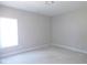A bare room with a window and unfinished concrete flooring at 788 Shade Tree Rd, Benson, NC 27504
