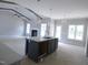 Open-concept kitchen and living room with island, pendant lighting, and fireplace at 788 Shade Tree Rd, Benson, NC 27504