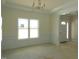 Bright living room features decorative molding, large window and chandelier at 788 Shade Tree Rd, Benson, NC 27504