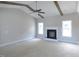 Cozy living room boasts beamed ceilings, a fireplace, and large windows for natural light at 788 Shade Tree Rd, Benson, NC 27504