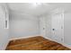 This bright bedroom has a clean, modern look with neutral paint, refinished hardwood floors, and two white doors at 833 Brigham Rd, Raleigh, NC 27610