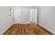 This room has a clean, modern look with neutral paint, refinished hardwood floors, and two white doors at 833 Brigham Rd, Raleigh, NC 27610