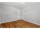 Bedroom has neutral walls, hardwood floors, and access to storage with two white doors and dark hardware at 833 Brigham Rd, Raleigh, NC 27610