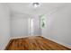 Bright bedroom featuring hardwood floors, fresh neutral paint, and a window that brings in natural light at 833 Brigham Rd, Raleigh, NC 27610