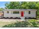 Charming single-story home featuring a bright red front door and freshly landscaped yard at 833 Brigham Rd, Raleigh, NC 27610