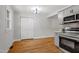 Open kitchen with hardwood floors, stainless steel appliances, and large pantry at 833 Brigham Rd, Raleigh, NC 27610