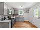 Well-lit kitchen with gray cabinets, subway tile backsplash, and stainless-steel appliances at 833 Brigham Rd, Raleigh, NC 27610
