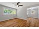 Bright living room with hardwood floors and a view into the well-lit kitchen at 833 Brigham Rd, Raleigh, NC 27610