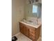 Bathroom vanity with wood cabinets, light countertop, large mirror, and tiled floor at 836 S Main St, Roxboro, NC 27573
