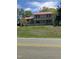 Two-story home featuring a brick exterior and a red metal roof at 836 S Main St, Roxboro, NC 27573