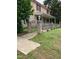 The house featuring a brick gate to the manicured front yard and covered porch at 836 S Main St, Roxboro, NC 27573