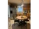Bright kitchen features stainless steel refrigerator and a round wooden table with black, cushioned chairs at 836 S Main St, Roxboro, NC 27573