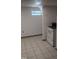 Small kitchen area featuring tiled floor, drop ceiling light, and a standard oven at 836 S Main St, Roxboro, NC 27573