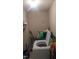 Laundry room with a modern, white washing machine and cleaning supplies at 836 S Main St, Roxboro, NC 27573